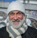 Amazed aged man in white knitted hat and scarf. Outdoor man portraite. Man Likes santa