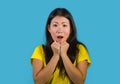 Amazed Asian Korean girl astonished and shocked in wonder and surprise gesturing with hands and wide open mouth isolated blue stud Royalty Free Stock Photo