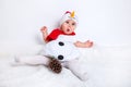 Amazed attractive baby girl in Christmas costume sitting and having fun Royalty Free Stock Photo