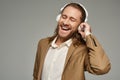 amazed bearded businessman in headphones listening