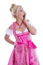 Amazed beautiful isolated bavarian woman wearing pink traditional dress.