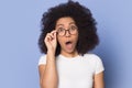 Amazed biracial woman in glasses shocked by sale offer Royalty Free Stock Photo