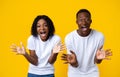 Amazed black couple screaming and showing their palms Royalty Free Stock Photo