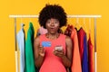 Amazed Black Female Shopping Holding Cellphone And Credit Card, Studio
