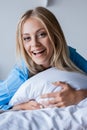 amazed blonde woman lying on pillow Royalty Free Stock Photo