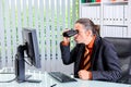 Amazed business man looking with binoculars at the screen Royalty Free Stock Photo