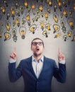 Amazed businessman pointing up index fingers, looking shocked as multiple light bulb float over his head. Impressed business Royalty Free Stock Photo