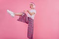 Amazed caucasian girl in sneakers fooling around during photoshoot. Indoor portrait of fashionable Royalty Free Stock Photo