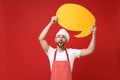 Amazed chef cook or baker man in striped apron white t-shirt toque chefs hat isolated on red background. Cooking food