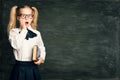 Amazed Child Girl on School Blackboard Background, Astonished Kid over Black Chalk Board Royalty Free Stock Photo