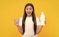 amazed child hold dairy beverage product. teen girl going to drink milk.