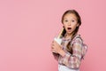 Amazed child holding milkshake with drinking