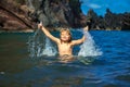 Amazed child playing and splashing in the sea. Kid having fun outdoors. Summer vacation and healthy family lifestyle Royalty Free Stock Photo