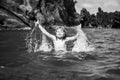 Amazed child playing and splashing in the sea. Kid having fun outdoors. Summer vacation and healthy family lifestyle Royalty Free Stock Photo