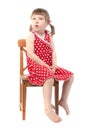 Amazed child sitting on a chair Royalty Free Stock Photo