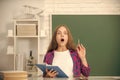 amazed child study at school with book on blackboard background, erudition