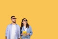 Amazed couple in 3D glasses with popcorn looking up in excitement Royalty Free Stock Photo