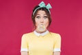 Amazed cute pinup girl blowing a bubble gum balloon Royalty Free Stock Photo