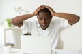 Amazed excited african-american man surprised by unexpected good Royalty Free Stock Photo