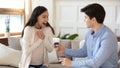 Amazed excited millennial girlfriend receiving marriage proposal from enamored boyfriend Royalty Free Stock Photo