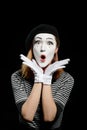 Amazed female mime on black. Vertical portrait of pantomime actress Royalty Free Stock Photo