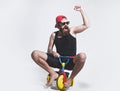 Amazed funny bicycle rider, excited man on colorful bicycle toy in sunglasses, cap. Guy riding childs tricycle. Royalty Free Stock Photo