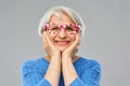 Amazed funny senior woman with big party glasses Royalty Free Stock Photo