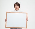 Amazed funny young woman holding blank board
