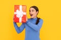 amazed girl with box on yellow background. boxing day. present and gifts buy. Royalty Free Stock Photo