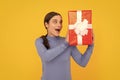 amazed girl with box on yellow background. boxing day. present and gifts buy. Royalty Free Stock Photo