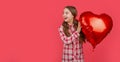 amazed girl hold love heart balloon on red background Royalty Free Stock Photo