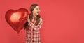 amazed girl hold love heart balloon on red background Royalty Free Stock Photo