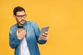 Amazed happy bearded man using digital tablet looking shocked about social media news, astonished man shopper consumer surprised Royalty Free Stock Photo