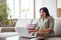 Amazed indian woman lottery winner look at laptop at home excited by online win. Royalty Free Stock Photo