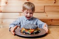 Amazed little child boy with vegetarian black burger, Royalty Free Stock Photo