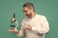 amazed man microscope for invention. photo of man holding microscope, invention Royalty Free Stock Photo