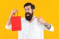 amazed man at shop sale isolated on yellow. man at shop sale in studio. man at shop sale