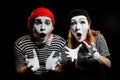 Amazed mimes with dropped jaws on black background Royalty Free Stock Photo