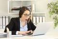 Amazed office worker reading good news in a computer