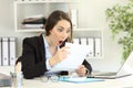 Amazed office worker reading a letter