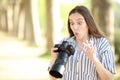 Amazed photographer checking result on mirrorless