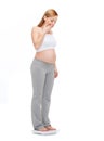 Amazed pregnant woman weighting herself Royalty Free Stock Photo