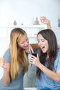 Amazed roommates watching offers on line with smart phone