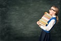 Amazed School Girl Holding Many Books, Astonished Strong Child Side View over Blackboard Royalty Free Stock Photo