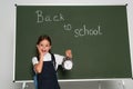 amazed schoolkid holding alarm clock near