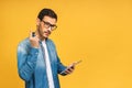 Amazed serious bearded man using digital tablet looking shocked about social media news, astonished man shopper consumer surprised Royalty Free Stock Photo