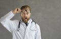 Amazed shocked doctor take off eyeglasses looking at camera studio shot Royalty Free Stock Photo