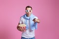 man using remote controller watching movie with big bucket of popcorns Royalty Free Stock Photo