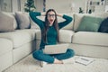 Amazed surprised funny funky screaming student holding laptop on legs sitting on floor touching head looking at camera Royalty Free Stock Photo