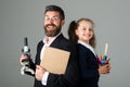 Amazed teacher with excited happy pupil school girl. Portrait of funny pupil schoolgirl and tutor with school supplies Royalty Free Stock Photo